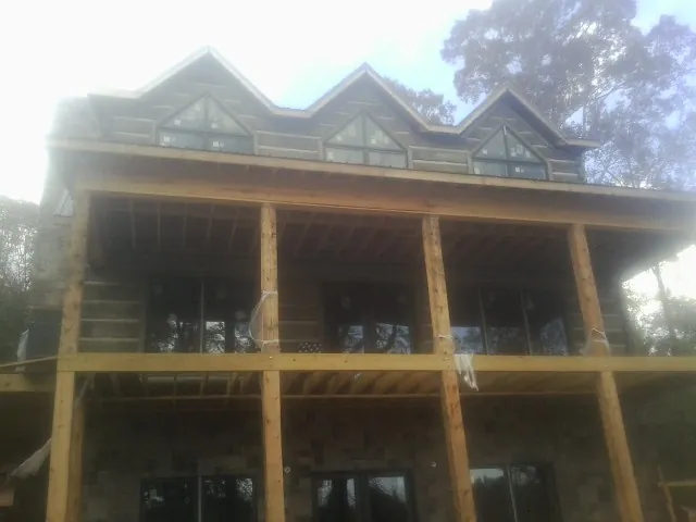 Dormers and porch framing on a large log home under construction in Lexington